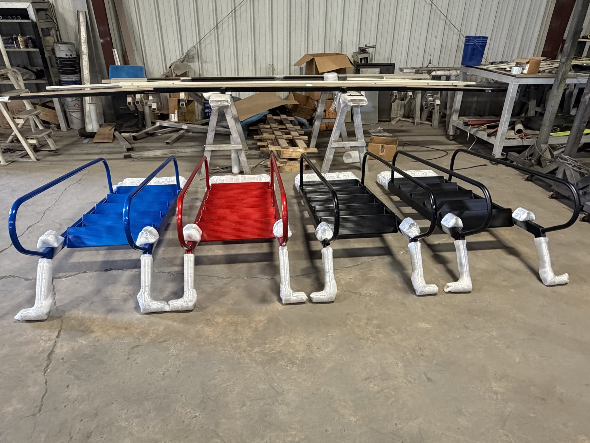 Boat boarding steps and handrails powder coated in blue, red and black, ready for delivery